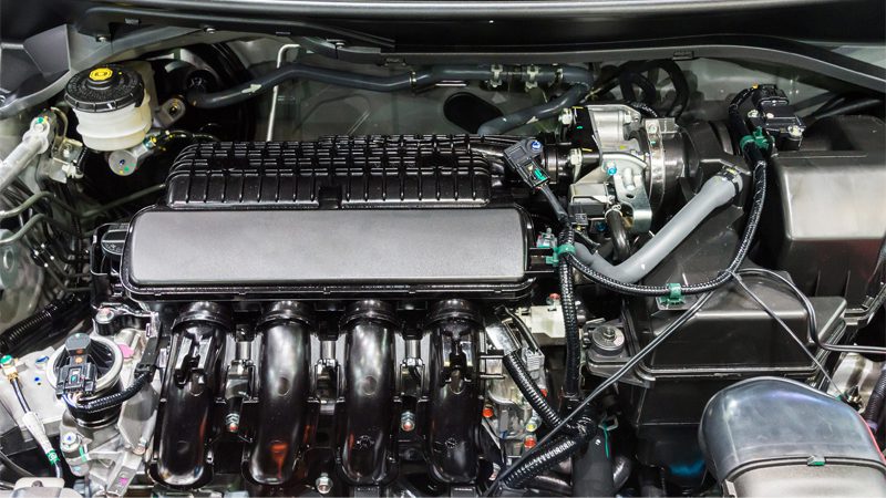 New gasoline engine of a modern sedan car, showcasing clean and compact design under the hood.