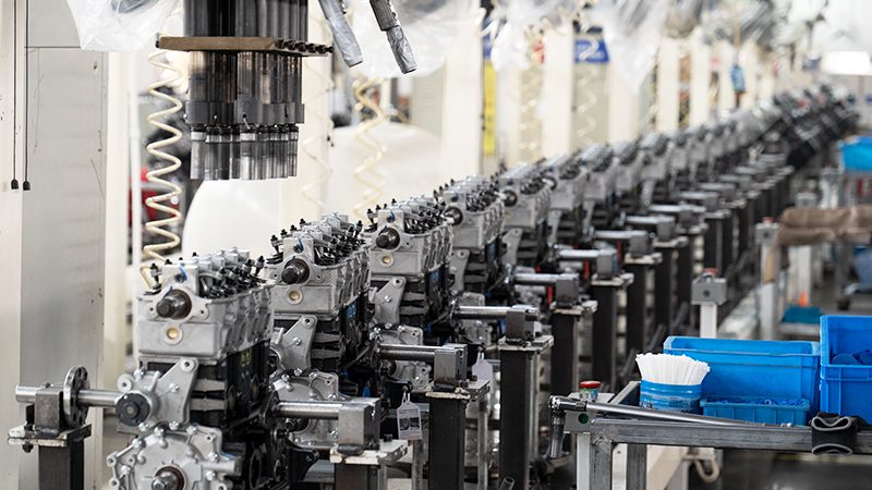 Engine production line at Woda Auto Technology's factory showing assembly of high-quality engine components for global distribution.