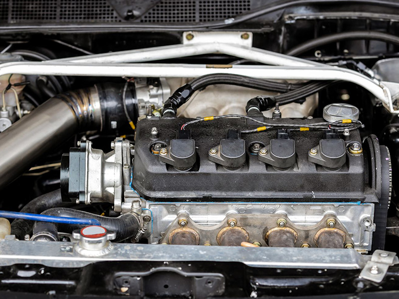 Car engine fuel injection system close-up showing engine components.