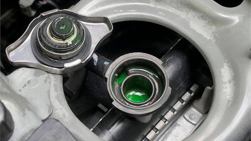 Close-up of a car radiator cap, part of the engine cooling system for controlling pressure and coolant levels.