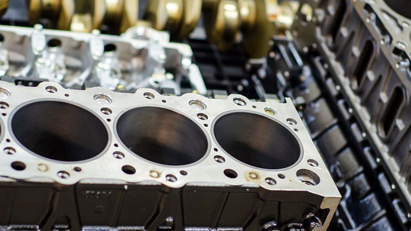 Close-up of new engine cylinder block for manufacturing inspection.