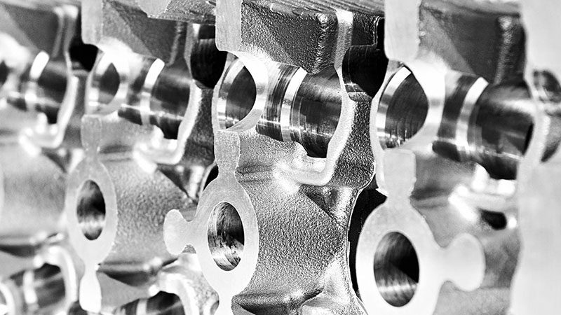 Metal cast cylinder block of a vehicle engine.