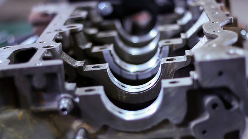 Open car engine cylinder block displaying crankshaft housing and internal structure.