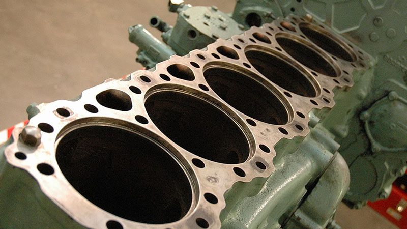 Close-up of a big block diesel engine highlighting the combustion chamber structure and components