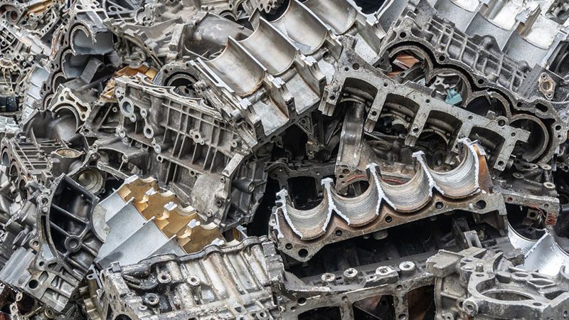 Pile of aluminum engine block scrap ready for recycling.