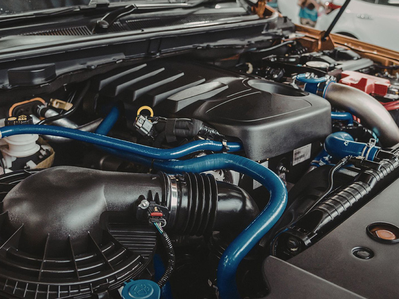 Detailed view of a car engine bay with visible engine components.