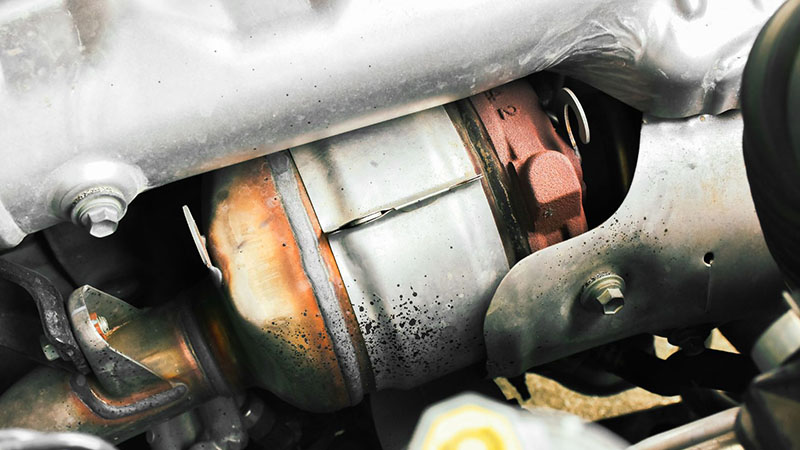 Close-up of catalytic converter in a car exhaust system.