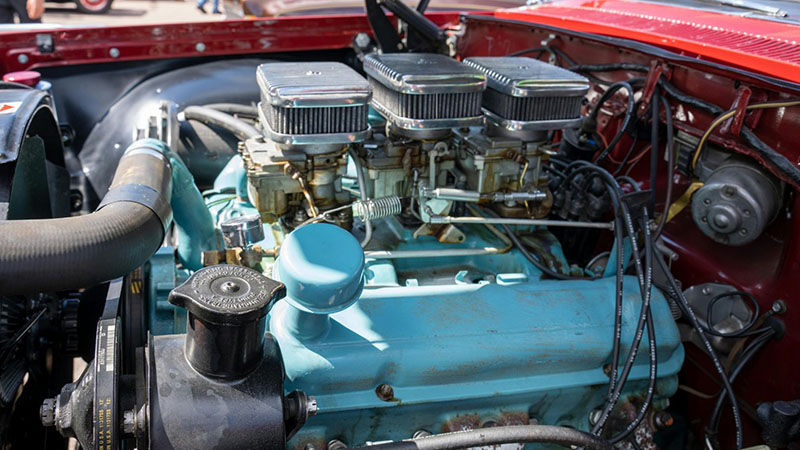 Classic car engine on display related to engine performance and restoration.