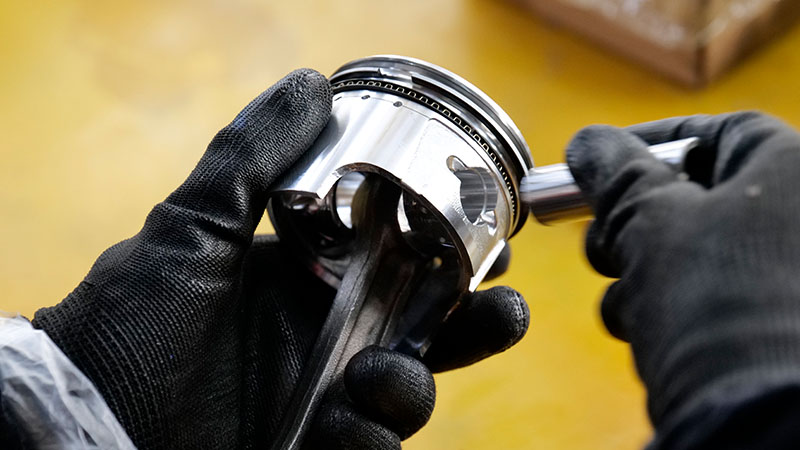 Installing new piston rings to fix oil consumption and improve engine sealing.