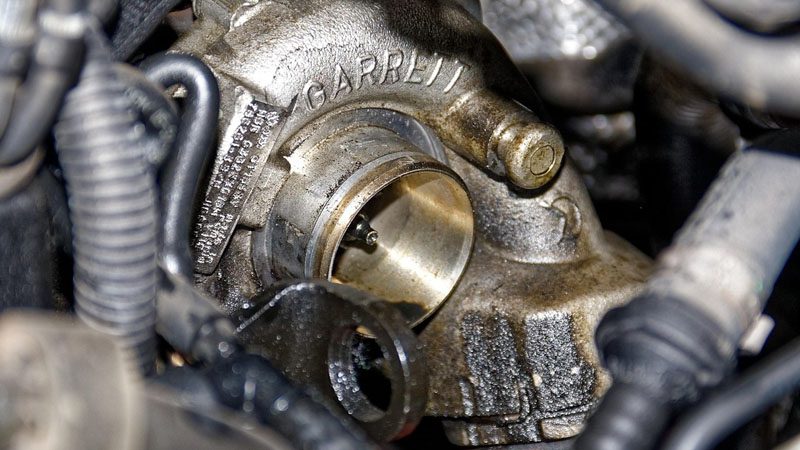 Oil sludge and metal shavings on an engine, indicating potential wear and the need for an engine overhaul.