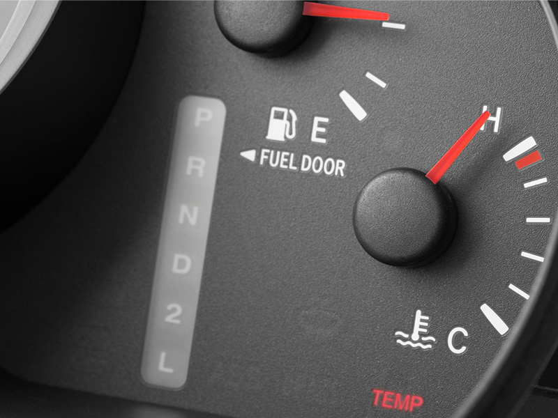 Vehicle dashboard showing temperature warning light indicating engine overheating.