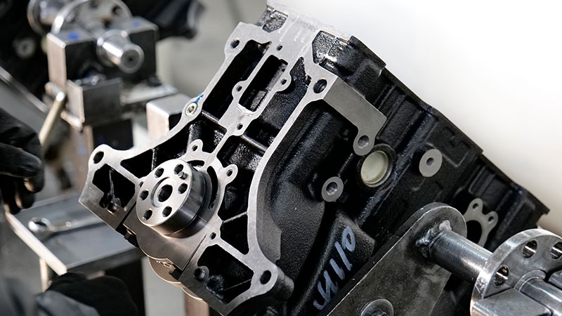 Close-up view of automotive engine production line in manufacturing facility.