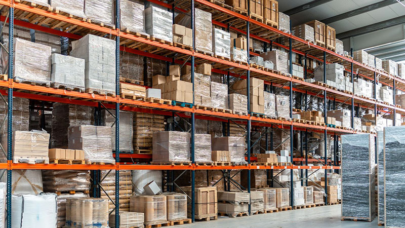 Commercial logistics warehouse with goods stored on tall racks for engine distribution.