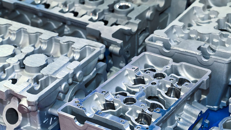 Cylinder heads prepared for installation in engine assembly process.