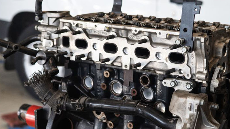 Automotive engine inspection at repair shop for maintenance and diagnostics.