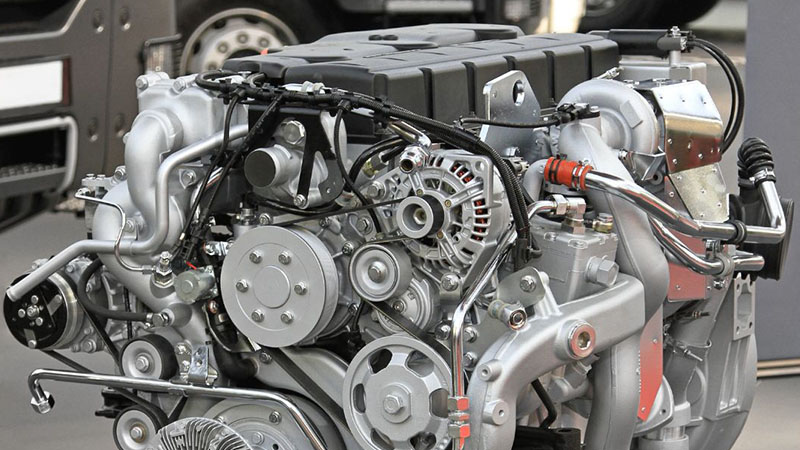 Close-up of a diesel engine showing key components and mechanical details.