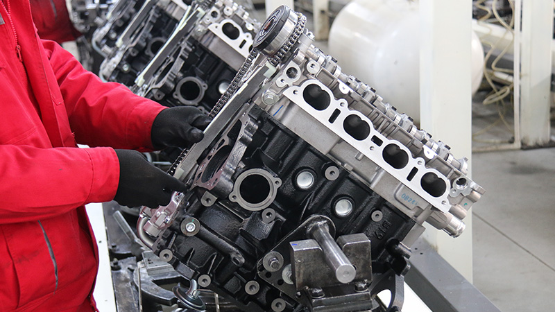 Auto engine assembly line at Woda Auto factory showing production and quality testing process.
