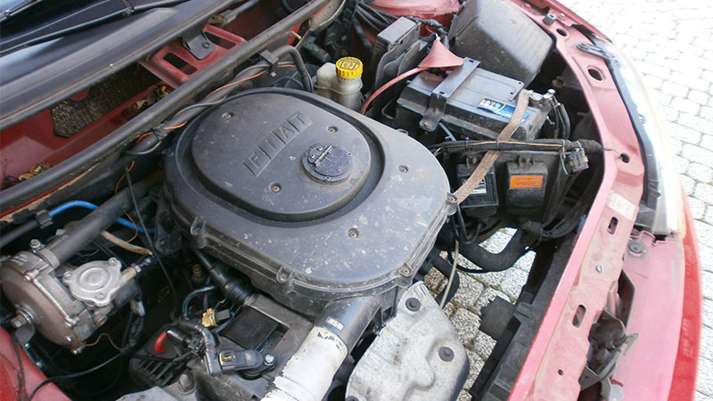 Fiat Punto with hood open showing FIRE engine inside.