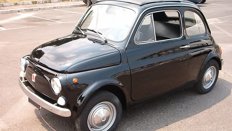 Black Fiat 500 classic car front view.