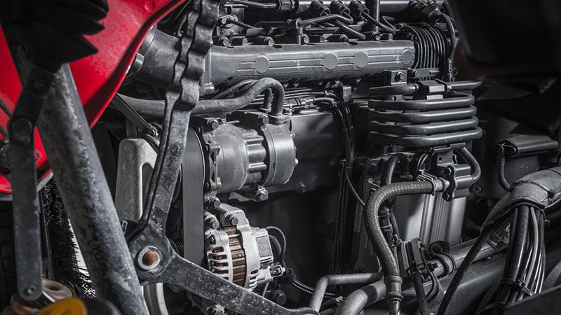 Close-up of a modern semi-truck diesel engine with detailed components visible.