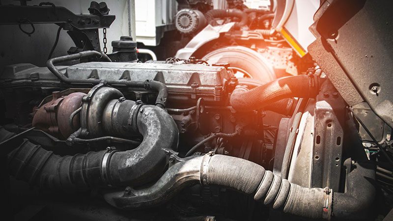 Truck tractor diesel engine opened for maintenance servicing.