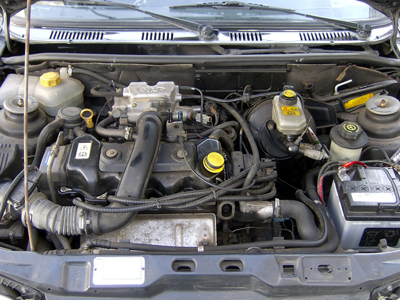Close-up view of Ford Fiesta Mk3 GFJ 1995 engine compartment under the hood.
