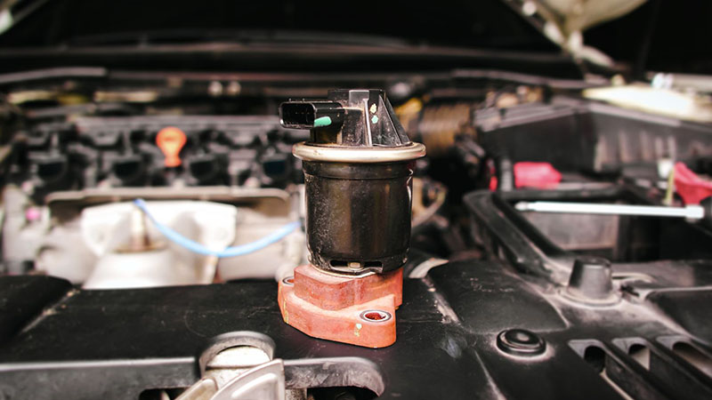 Damaged EGR exhaust gas recirculation valve close-up.
