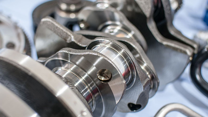 Detailed view of an engine crankshaft showing machined surfaces and journals.