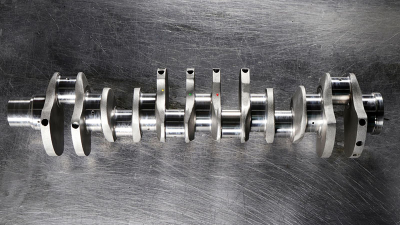 Detailed close-up of a new crankshaft emphasizing surface quality and machining precision.
