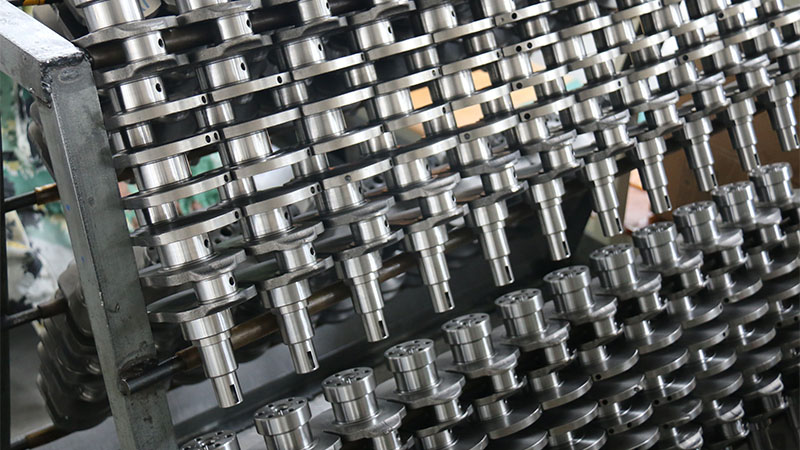 New engine crankshafts displayed at Woda Auto factory ready for engine assembly.