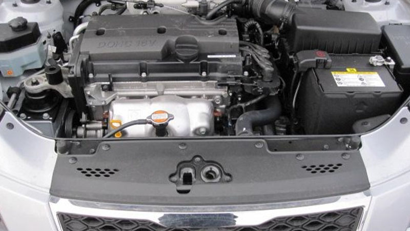 Kia Rio with the hood open showing the engine bay.