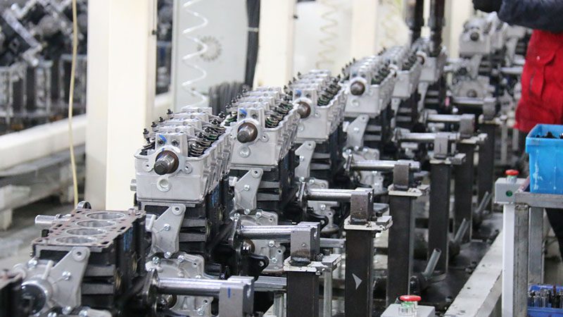 Close-up of auto engine production line at Nanjing Woda Auto factory showcasing precision manufacturing