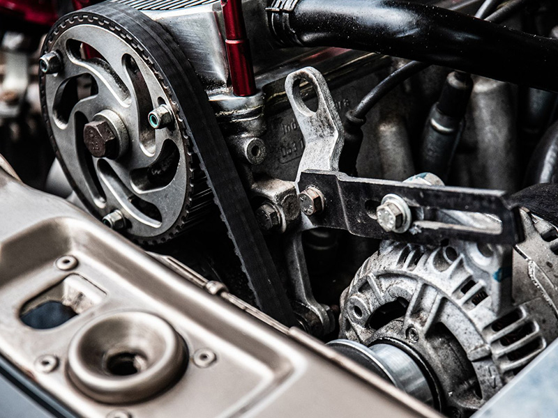 Close-up photo of a black and silver car engine showing detailed components and metallic finishes.