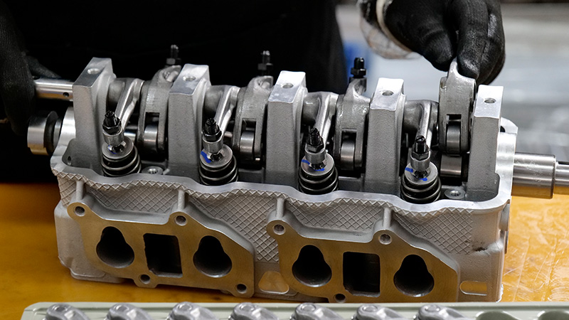 Cylinder head assembly line at Woda Auto factory showcasing high-quality engine parts production.