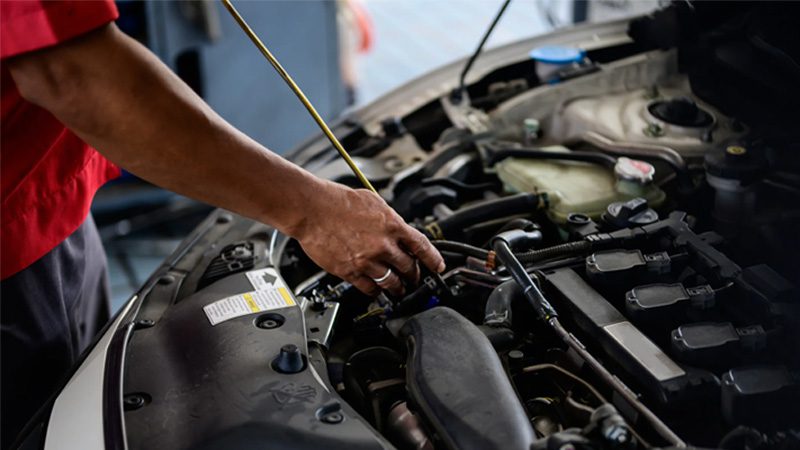 Troca de óleo do motor com adesivo de lembrete de troca de óleo no carro.