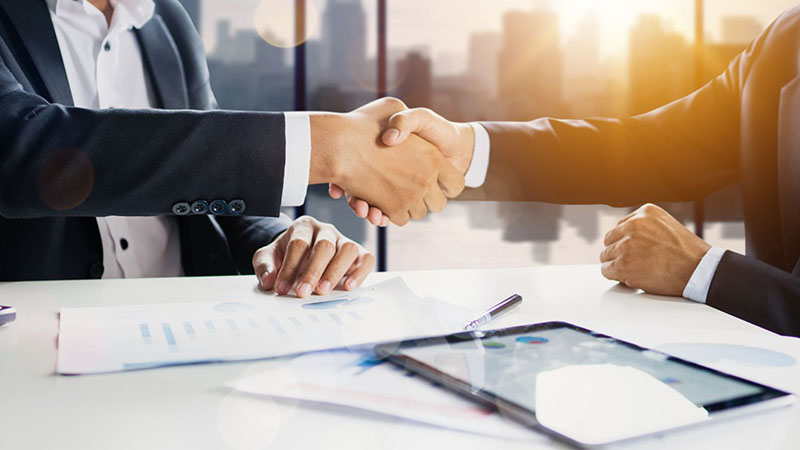 Corporate deal concept showing business partners shaking hands, representing successful supplier partnerships and cooperation.