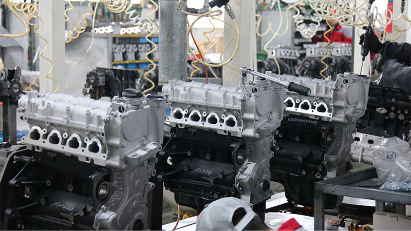 Close-up view of automotive engine assembly line at factory.