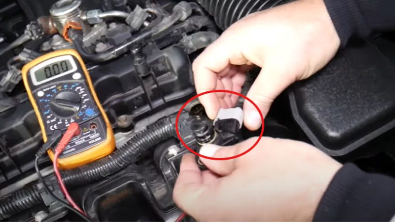 Reattaching the connector to the camshaft position sensor.