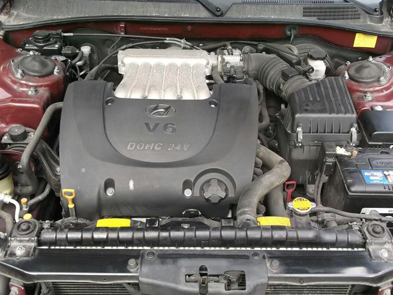 2004 Hyundai Sonata 2.7L V6 engine installed under the hood, showing the engine bay and surrounding components.