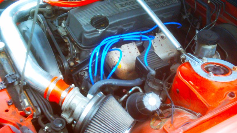 KA24E engine in a 1990 Nissan 240SX, showcasing the engine setup and modifications for performance.