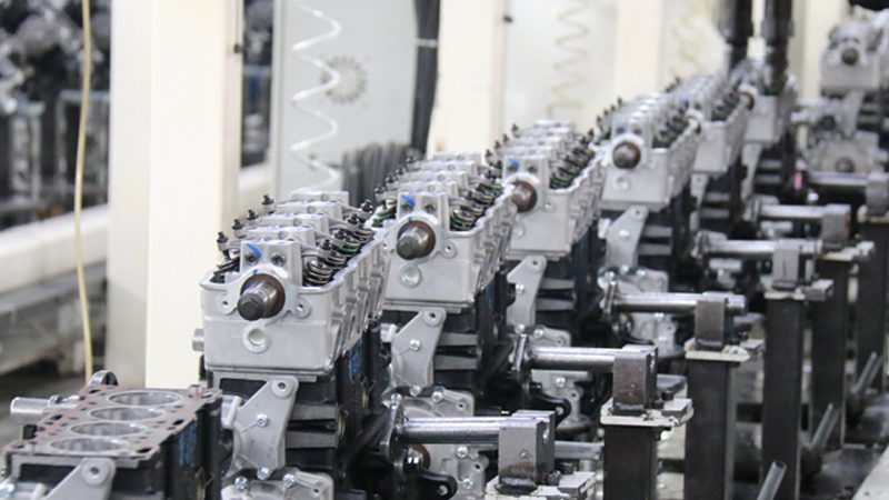 Engine production line at Nanjing Woda Auto Technology's factory, showcasing assembled engine units and manufacturing process.
