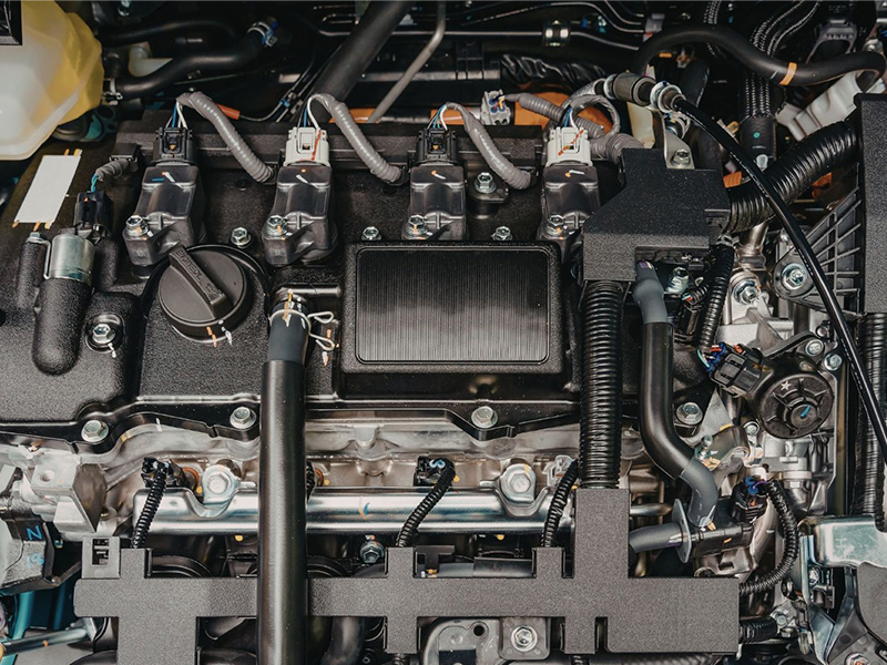 Detailed view of a modern automotive engine compartment with advanced engine components.