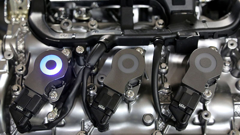 Close-up of modern engine fuel injectors used in direct injection systems.