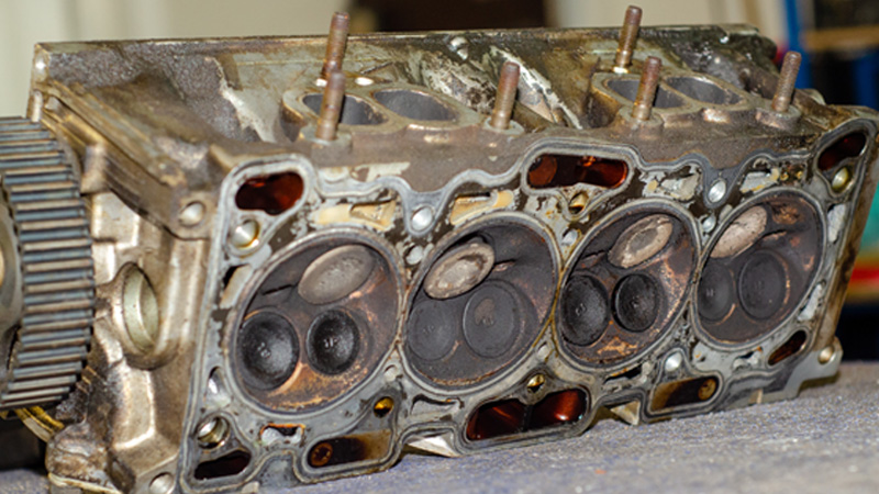 Carbon deposits formed on engine valves, which can contribute to sealing problems and low engine compression.
