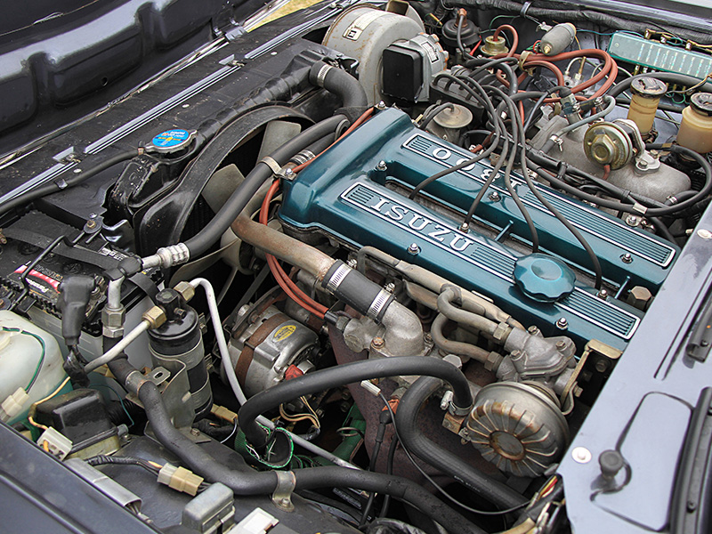 Close up of Isuzu diesel engine with Isuzu logo showing engine detail.