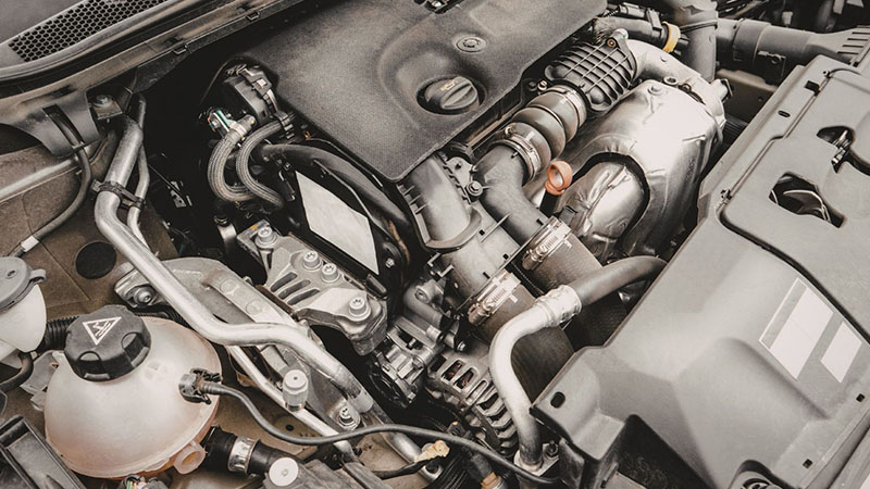 Car engine bay components showing modern engine layout.