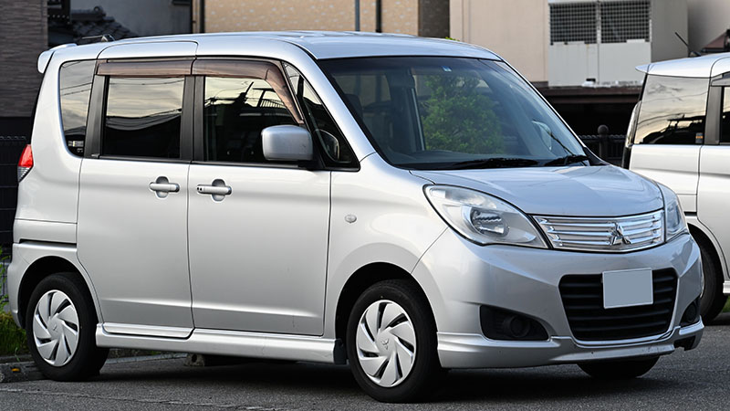 Front view of Mitsubishi compact MPV in urban setting.