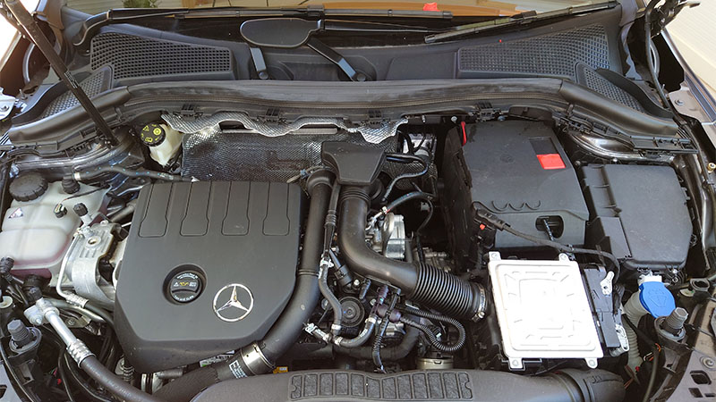 Mercedes-Benz car with the hood open, showing the engine bay.