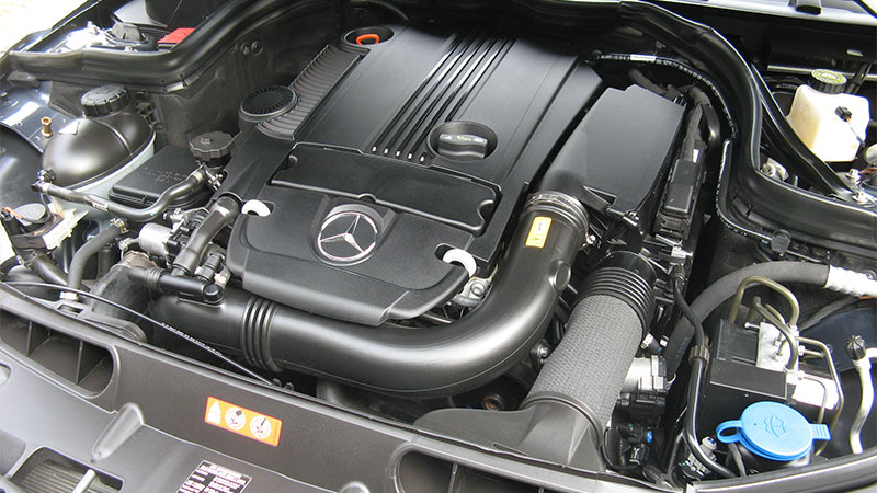 Close-up of a Mercedes-Benz engine bay under the hood.