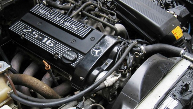 Mercedes-Benz M102 engine under the hood.